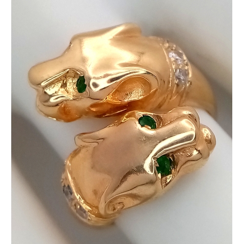 37 - A 14K Yellow Gold, Emerald and Diamond Twin Panther Crossover Ring. Emerald eyes and diamond set nec... 