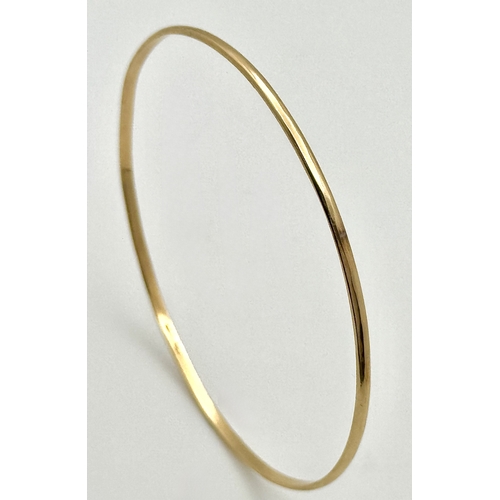 527 - A 14K Yellow Gold Thin Bangle. 3mm width. 62mm inner diameter. 5.05g.
