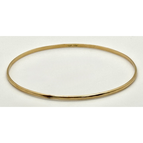527 - A 14K Yellow Gold Thin Bangle. 3mm width. 62mm inner diameter. 5.05g.