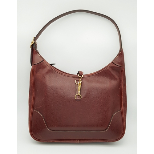 A Herm&egrave;s Trim 31 Shoulder Bag. Brown leather exterior with gold-tone hardware, featuring a single adjustable shoulder strap and squeeze lock and zipped top closure with leather pull tab. Matching brown leather interior with an open inner side pocket and a zipped inner side pocket. Approximately 31cm length x 30cm height. Signs of wear to edges and corners, and signs of use to the interior &ndash; please see photos or request a condition report. Ref: 27946