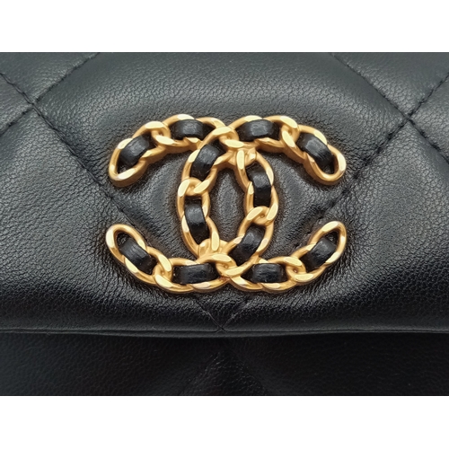 5 - A Chanel 19 Black Leather Wallet On Chain. Black quilted leather exterior with mixed gold and silver... 
