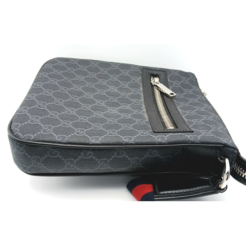 26 - A Black Gucci GG Canvas Web Stripe Crossbody Bag. Black GG monogram canvas exterior with silver-tone... 