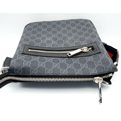 26 - A Black Gucci GG Canvas Web Stripe Crossbody Bag. Black GG monogram canvas exterior with silver-tone... 