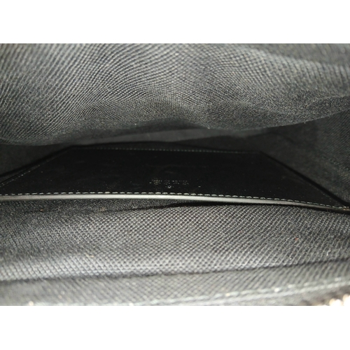 26 - A Black Gucci GG Canvas Web Stripe Crossbody Bag. Black GG monogram canvas exterior with silver-tone... 