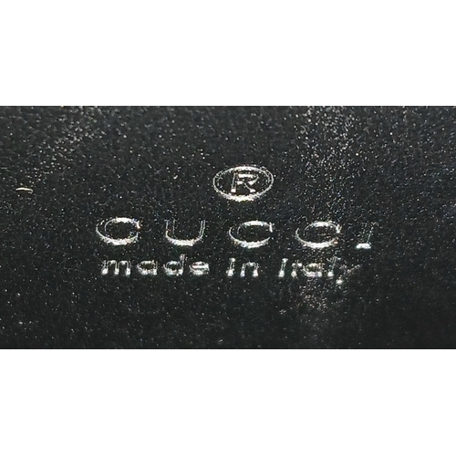 26 - A Black Gucci GG Canvas Web Stripe Crossbody Bag. Black GG monogram canvas exterior with silver-tone... 