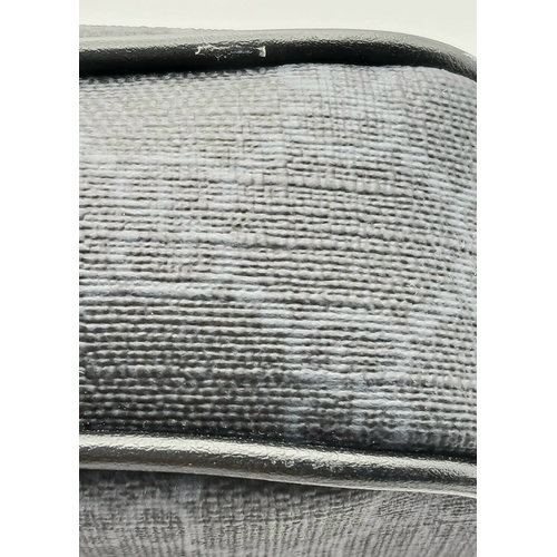 26 - A Black Gucci GG Canvas Web Stripe Crossbody Bag. Black GG monogram canvas exterior with silver-tone... 