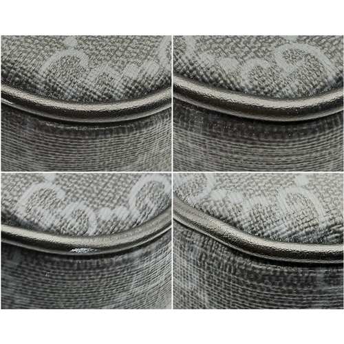 26 - A Black Gucci GG Canvas Web Stripe Crossbody Bag. Black GG monogram canvas exterior with silver-tone... 