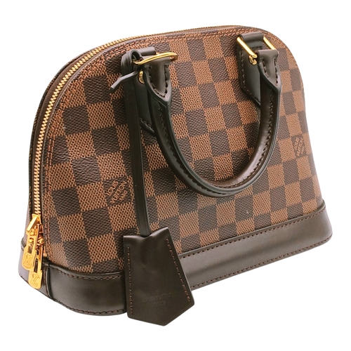 33 - A Brown Louis Vuitton Damier Ebene Alma BB Handbag. Brown textile exterior with gold-tone hardware, ... 