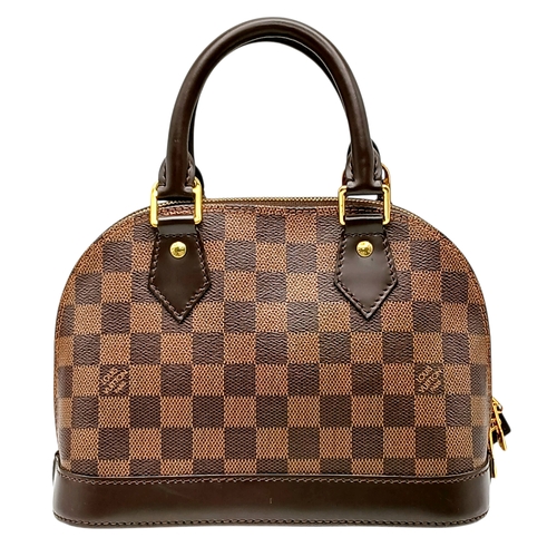 33 - A Brown Louis Vuitton Damier Ebene Alma BB Handbag. Brown textile exterior with gold-tone hardware, ... 