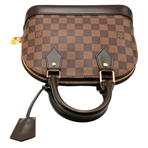 33 - A Brown Louis Vuitton Damier Ebene Alma BB Handbag. Brown textile exterior with gold-tone hardware, ... 