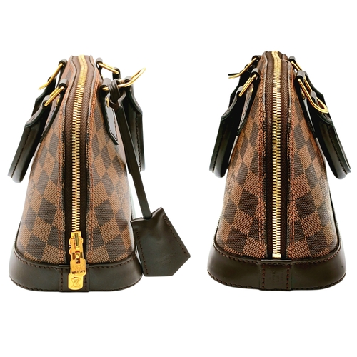 33 - A Brown Louis Vuitton Damier Ebene Alma BB Handbag. Brown textile exterior with gold-tone hardware, ... 