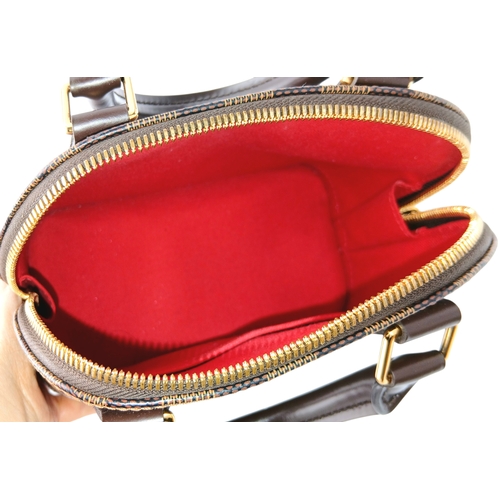 33 - A Brown Louis Vuitton Damier Ebene Alma BB Handbag. Brown textile exterior with gold-tone hardware, ... 