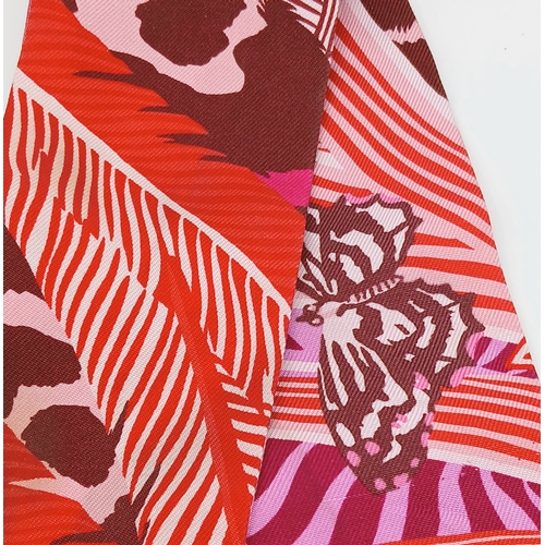 550 - Two Hermès “Jaguar Quetzal” Twilly Scarves. In a vibrant pink, rose and bordeaux colour palette with... 