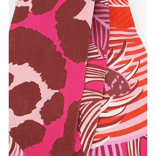 550 - Two Hermès “Jaguar Quetzal” Twilly Scarves. In a vibrant pink, rose and bordeaux colour palette with... 