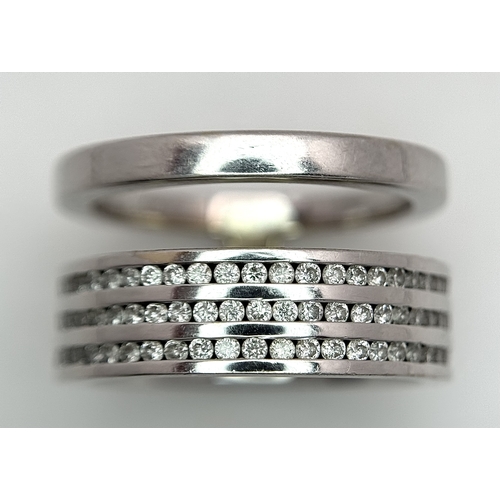 507 - An 18K White Gold and Diamond Band Ring. A split band with three channel set diamond full eternity r... 