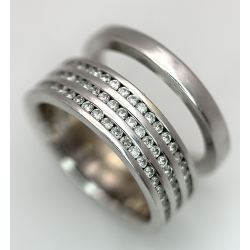 507 - An 18K White Gold and Diamond Band Ring. A split band with three channel set diamond full eternity r... 
