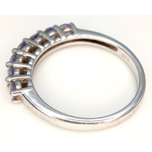 525 - Classic Slim  TANZANITE RING from The Genuine Gemstone Company. Having a Sweep of  7 x TANZANITE GEM... 