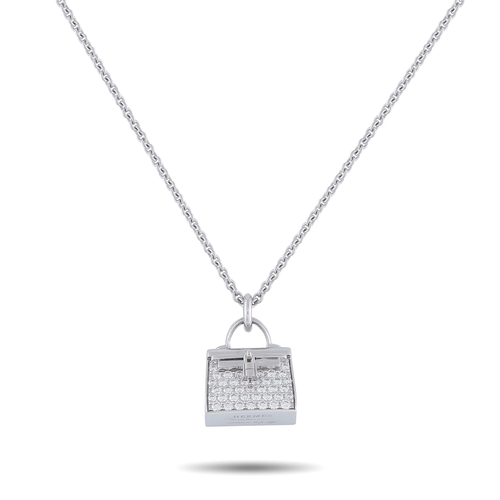 A Hermes Amulettes Birkin 18K White Gold Diamond Pendant Necklace. A Birkin pendant takes center stage set with Sparkling Diamonds, measures 0.63 inches long by 0.50 inches wide and is suspended from a 15.50 inches chain. In Excellent Condition and includes a gift box. Total weight: 12.6 grams. *This item is held at Cadmore USA Office in Pennsylvania, USA and will be shipped from there. Buyers will be responsible for direct shipping payments.* ID: 320633