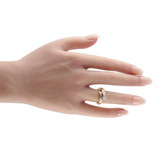 1172 - An 18K Yellow Gold 1.28ct Diamond Ring. A stunning wrapped setting, it features a 0.61 Diamond cente... 