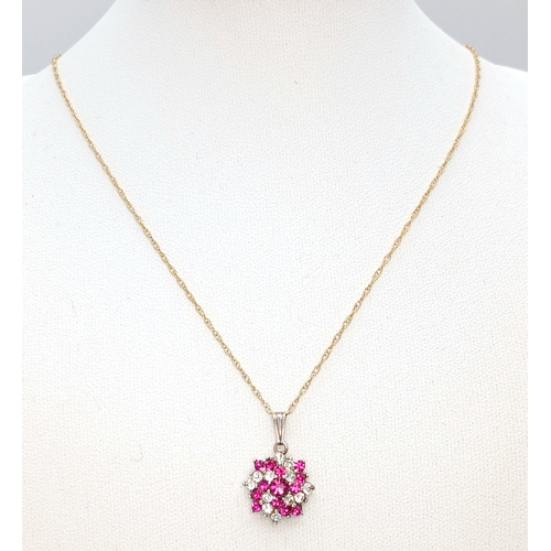 1160 - A charming 9k gold chain and a 925 silver floral pendant. 
The pendant is designed in a floral clust... 