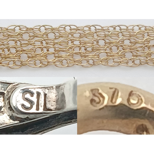 1160 - A charming 9k gold chain and a 925 silver floral pendant. 
The pendant is designed in a floral clust... 