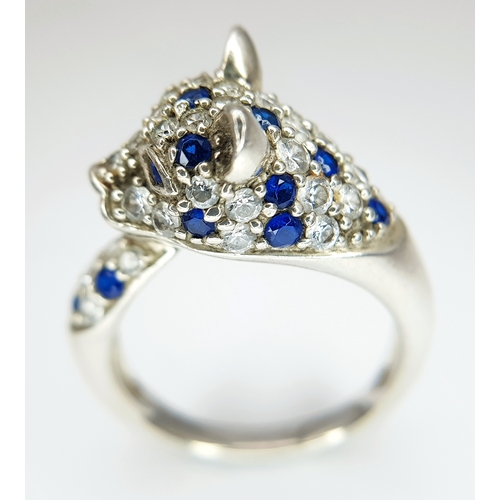 1168 - A Sterling Silver Blue and White Gem Set Panther Ring Size R. The Ring
measures 1.2cm wide at the wi... 