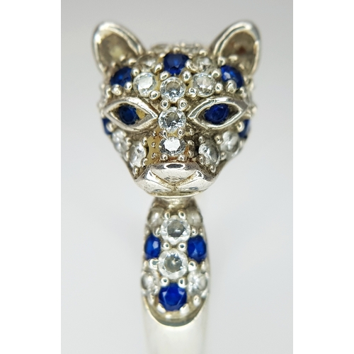 1168 - A Sterling Silver Blue and White Gem Set Panther Ring Size R. The Ring
measures 1.2cm wide at the wi... 