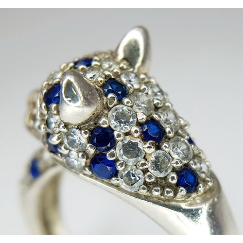 1168 - A Sterling Silver Blue and White Gem Set Panther Ring Size R. The Ring
measures 1.2cm wide at the wi... 