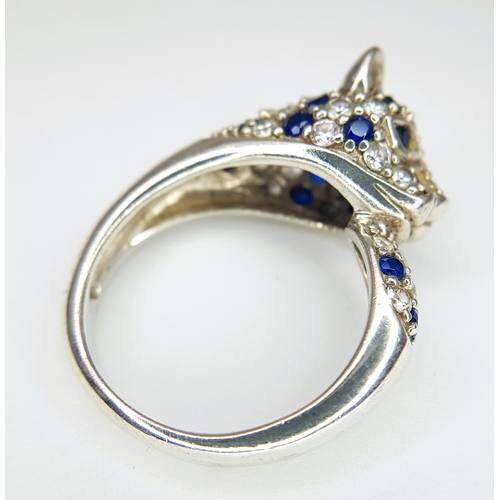 1168 - A Sterling Silver Blue and White Gem Set Panther Ring Size R. The Ring
measures 1.2cm wide at the wi... 