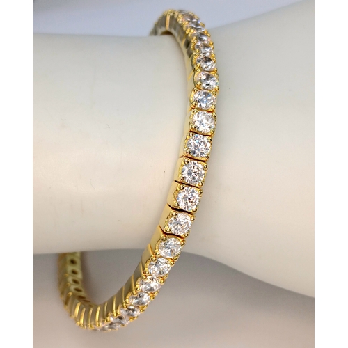 1153 - A gold-plated 925 silver tennis bracelet with CZ stones. Features an expandable design with faceted ... 