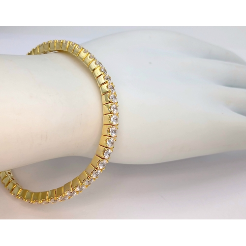 1153 - A gold-plated 925 silver tennis bracelet with CZ stones. Features an expandable design with faceted ... 