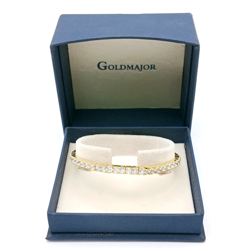 1153 - A gold-plated 925 silver tennis bracelet with CZ stones. Features an expandable design with faceted ... 
