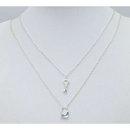1155 - A STERLING SILVER PADLOCK PENDANT ON CHAIN ALONG WITH ANOTHER STERLING SILVER KEY PENDANT ON CHAIN. ... 