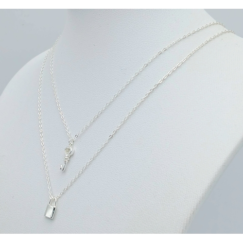 1155 - A STERLING SILVER PADLOCK PENDANT ON CHAIN ALONG WITH ANOTHER STERLING SILVER KEY PENDANT ON CHAIN. ... 