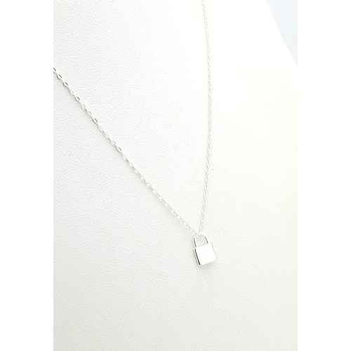 1155 - A STERLING SILVER PADLOCK PENDANT ON CHAIN ALONG WITH ANOTHER STERLING SILVER KEY PENDANT ON CHAIN. ... 
