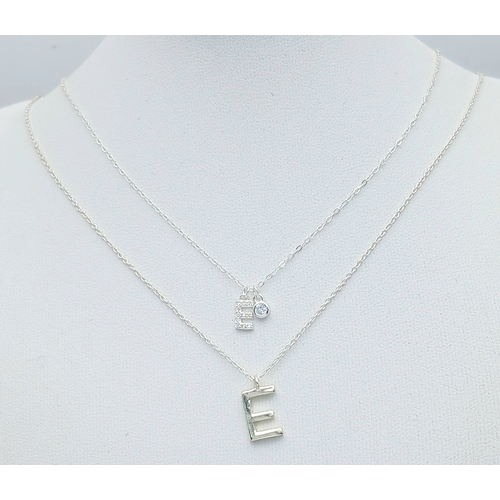 1189 - A PAIR OF STERLING SILVER NECKLACES WITH INITIAL E PENDANTS. ONE IS STONE SET. TOTAL WEIGHT 2.5G. A/... 
