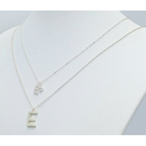 1189 - A PAIR OF STERLING SILVER NECKLACES WITH INITIAL E PENDANTS. ONE IS STONE SET. TOTAL WEIGHT 2.5G. A/... 