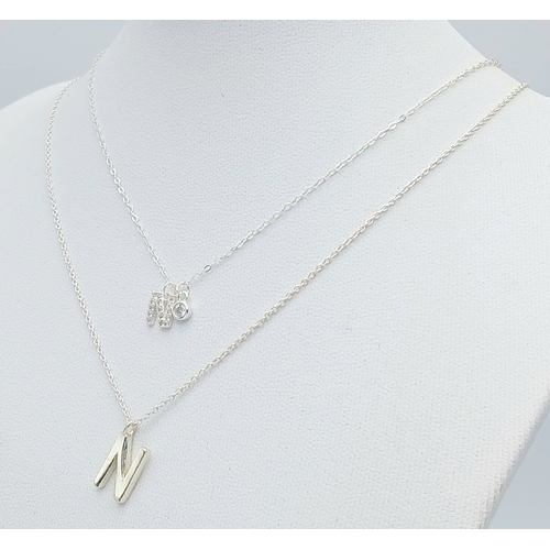 1196 - A PAIR OF STERLING SILVER NECKLACES WITH INITIAL N PENDANTS. ONE IS STONE SET. TOTAL WEIGHT 2.7G. A/... 