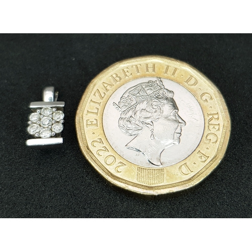 1204 - A Pretty 9k White Diamond Set Pendant. 1.6cm Length. Set with Seven Round Cut Diamonds, total 0.13 c... 