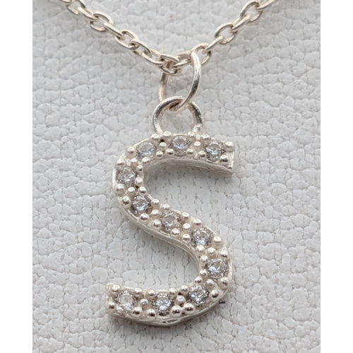 1210 - A PAIR OF STERLING SILVER NECKLACES WITH INITIAL S PENDANTS. ONE IS STONE SET. TOTAL WEIGHT 2.9G. A/... 