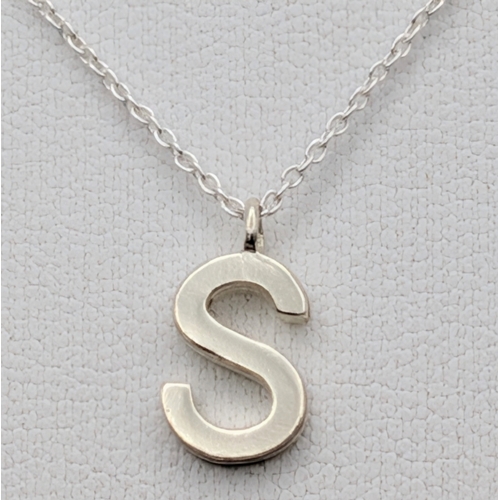 1210 - A PAIR OF STERLING SILVER NECKLACES WITH INITIAL S PENDANTS. ONE IS STONE SET. TOTAL WEIGHT 2.9G. A/... 
