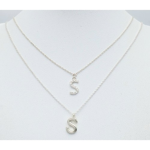 1210 - A PAIR OF STERLING SILVER NECKLACES WITH INITIAL S PENDANTS. ONE IS STONE SET. TOTAL WEIGHT 2.9G. A/... 