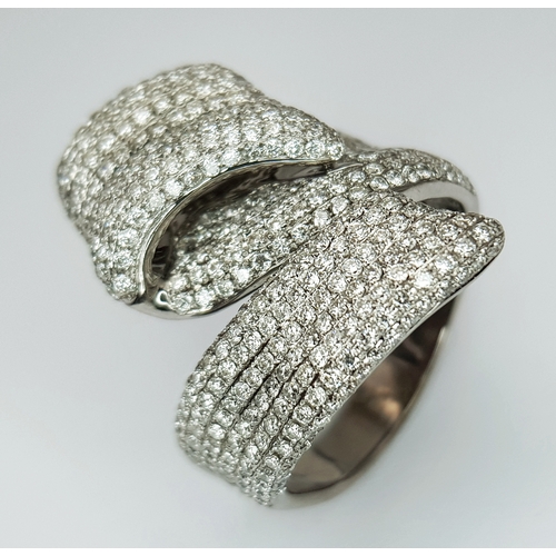 29 - An 18K White Gold Diamond Statement Ring. Abstract crossover form with c.4ctw of round brilliant cut... 