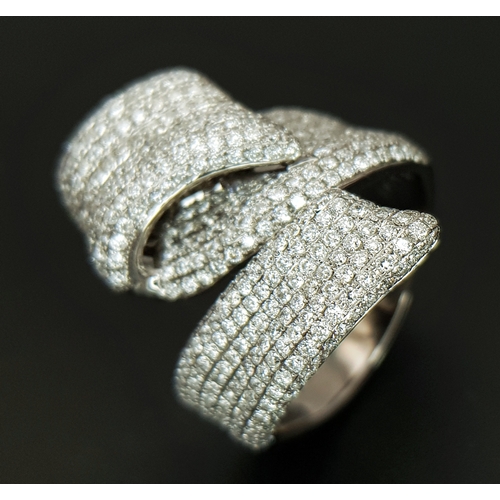 29 - An 18K White Gold Diamond Statement Ring. Abstract crossover form with c.4ctw of round brilliant cut... 