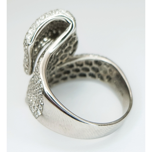 29 - An 18K White Gold Diamond Statement Ring. Abstract crossover form with c.4ctw of round brilliant cut... 