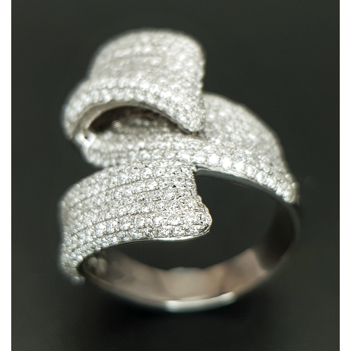 29 - An 18K White Gold Diamond Statement Ring. Abstract crossover form with c.4ctw of round brilliant cut... 