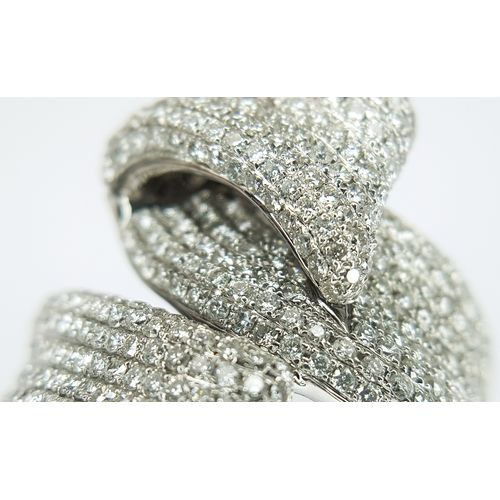 29 - An 18K White Gold Diamond Statement Ring. Abstract crossover form with c.4ctw of round brilliant cut... 