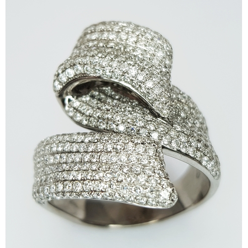 29 - An 18K White Gold Diamond Statement Ring. Abstract crossover form with c.4ctw of round brilliant cut... 