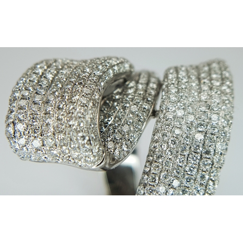 29 - An 18K White Gold Diamond Statement Ring. Abstract crossover form with c.4ctw of round brilliant cut... 