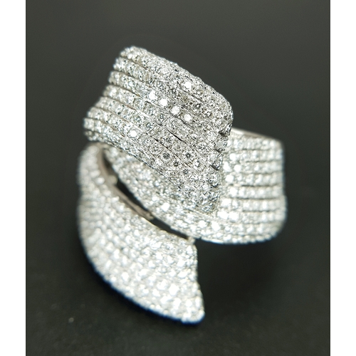 29 - An 18K White Gold Diamond Statement Ring. Abstract crossover form with c.4ctw of round brilliant cut... 
